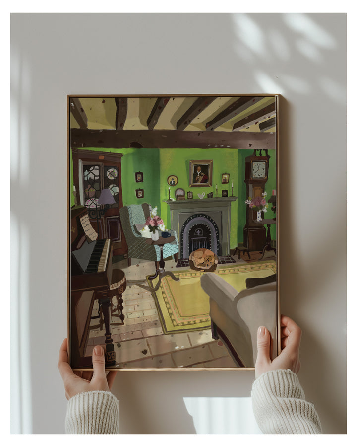 Framed artwork of a room scene held by two hands against a white wall.