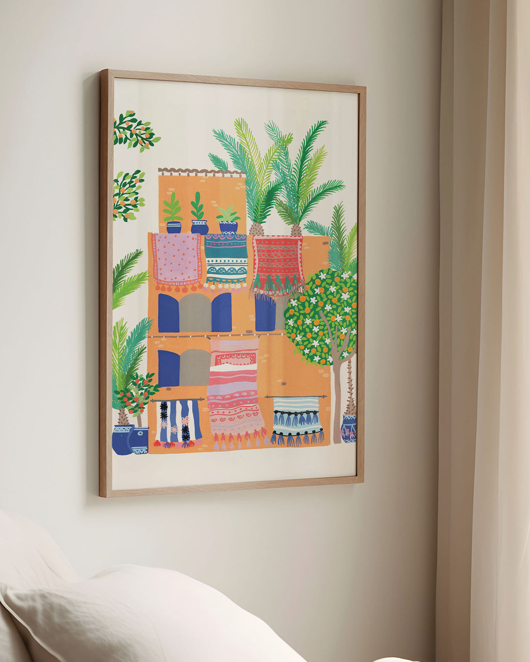 Framed Wall Art of a Middle Eastern style abode with patterned rugs, potted plants, and palm trees by Little Berries Studio.