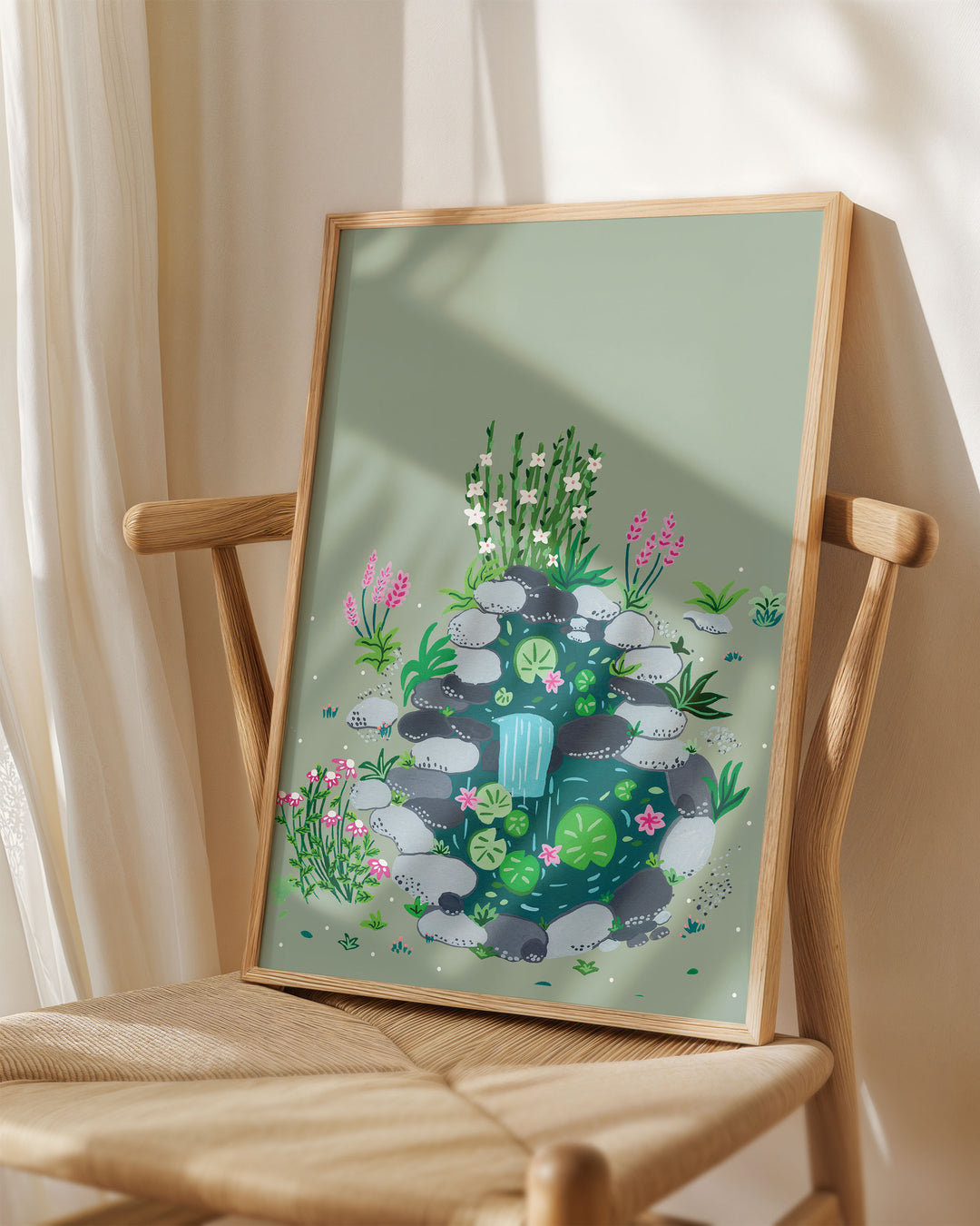 Framed Art Print titled 'Babbling Brook' by Little Berries Studio, placed on a wooden chair in a softly lit room.