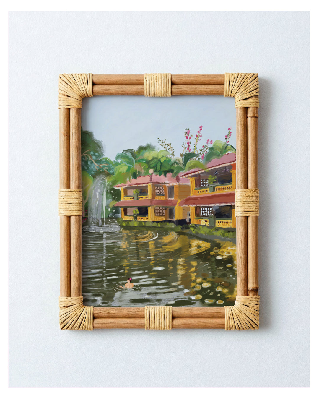 Framed artwork of a scenic house by a lake from Bhubaneswar with a bamboo frame.