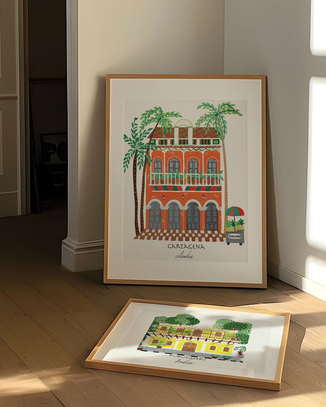 Framed Artwork of a charming Cartagena building with vibrant orange facade, green balconies, and palm trees, capturing the lively spirit of Colombia.
