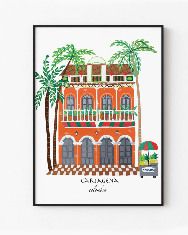 Black Framed Artwork of a charming Cartagena building with vibrant orange facade, green balconies, and palm trees, capturing the lively spirit of Colombia.