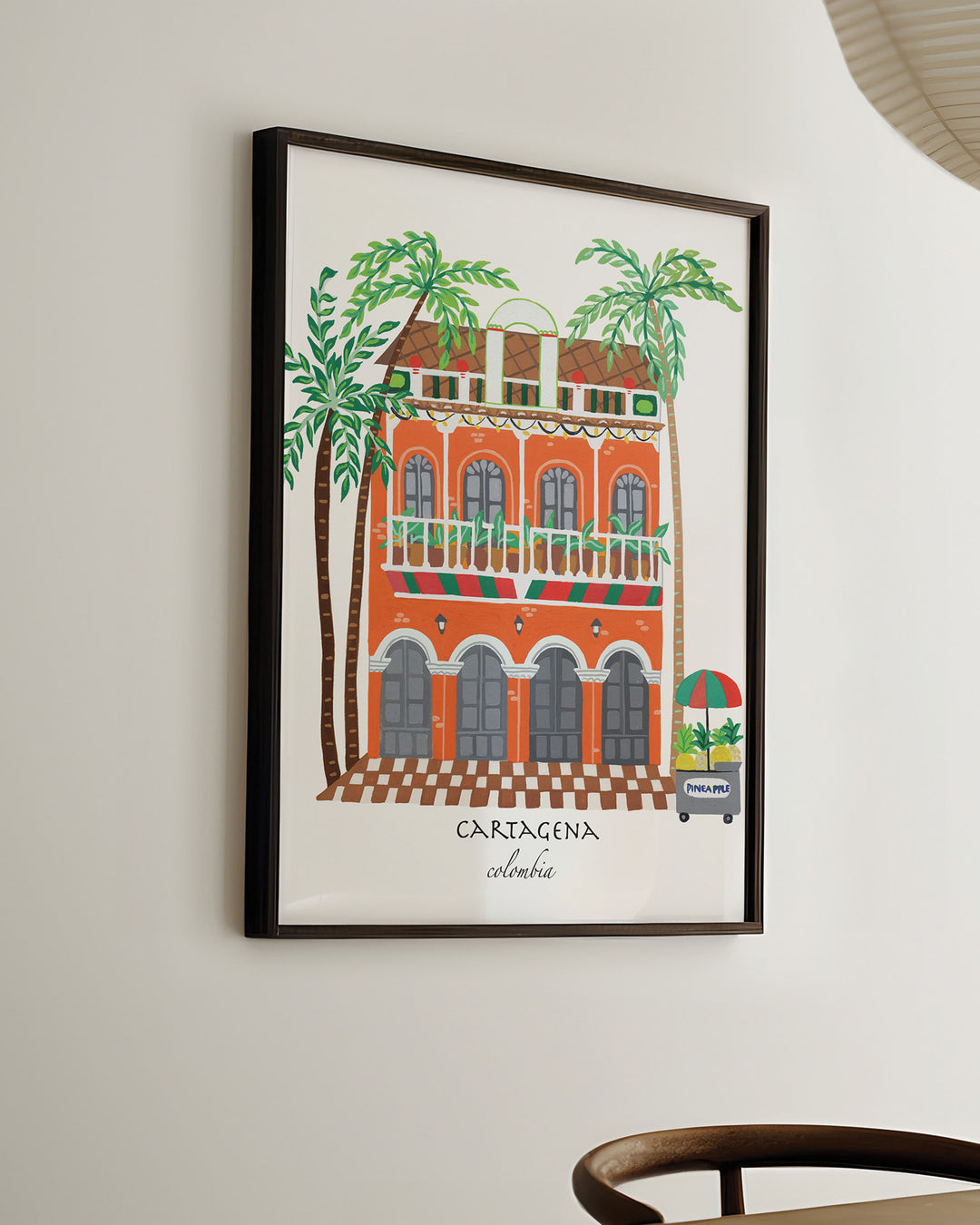 Ready-to-Hang Framed Wall Art of a charming Cartagena building with vibrant orange facade, green balconies, and palm trees, capturing the lively spirit of Colombia.