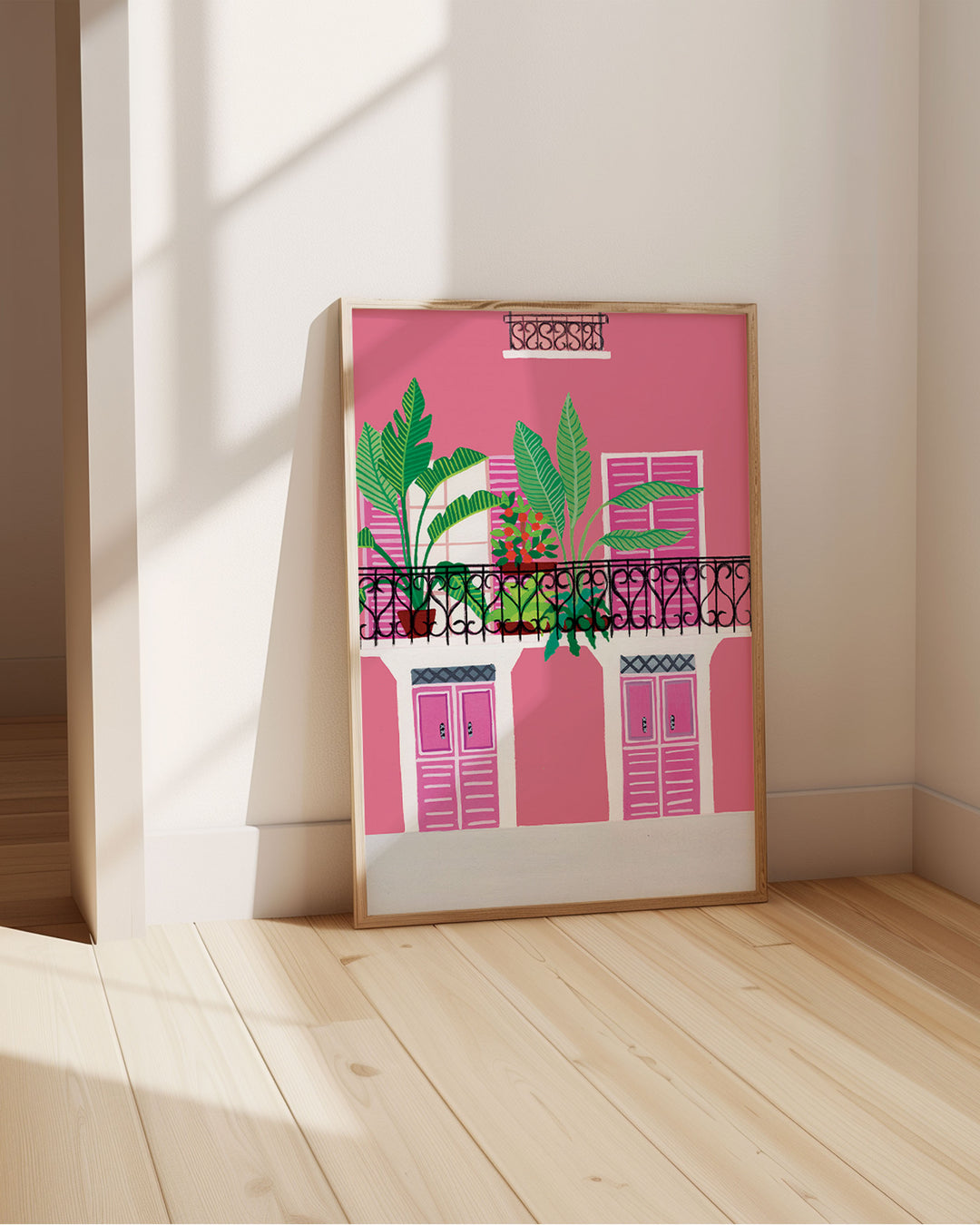 Framed Art Print titled 'Door Bloom Balcony' by Little Berries Studio, propped against a bright wall, in a sunlit room.
