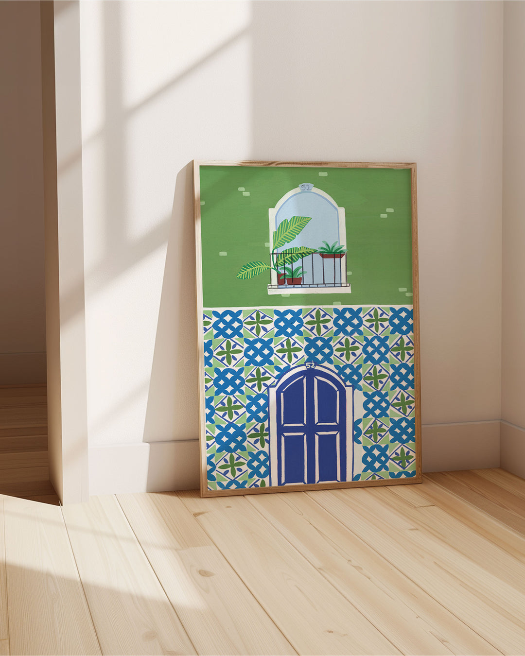 Framed Art Print titled 'Door Mediterranean Mosaic' by Little Berries Studio, propped against a bright wall, in a sunlit room.
