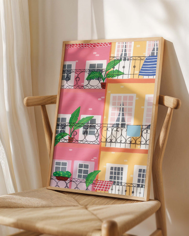 Framed Art Print titled "Door Urban Pastels" by Little Berries Studio, placed on a wooden chair in a softly lit room.