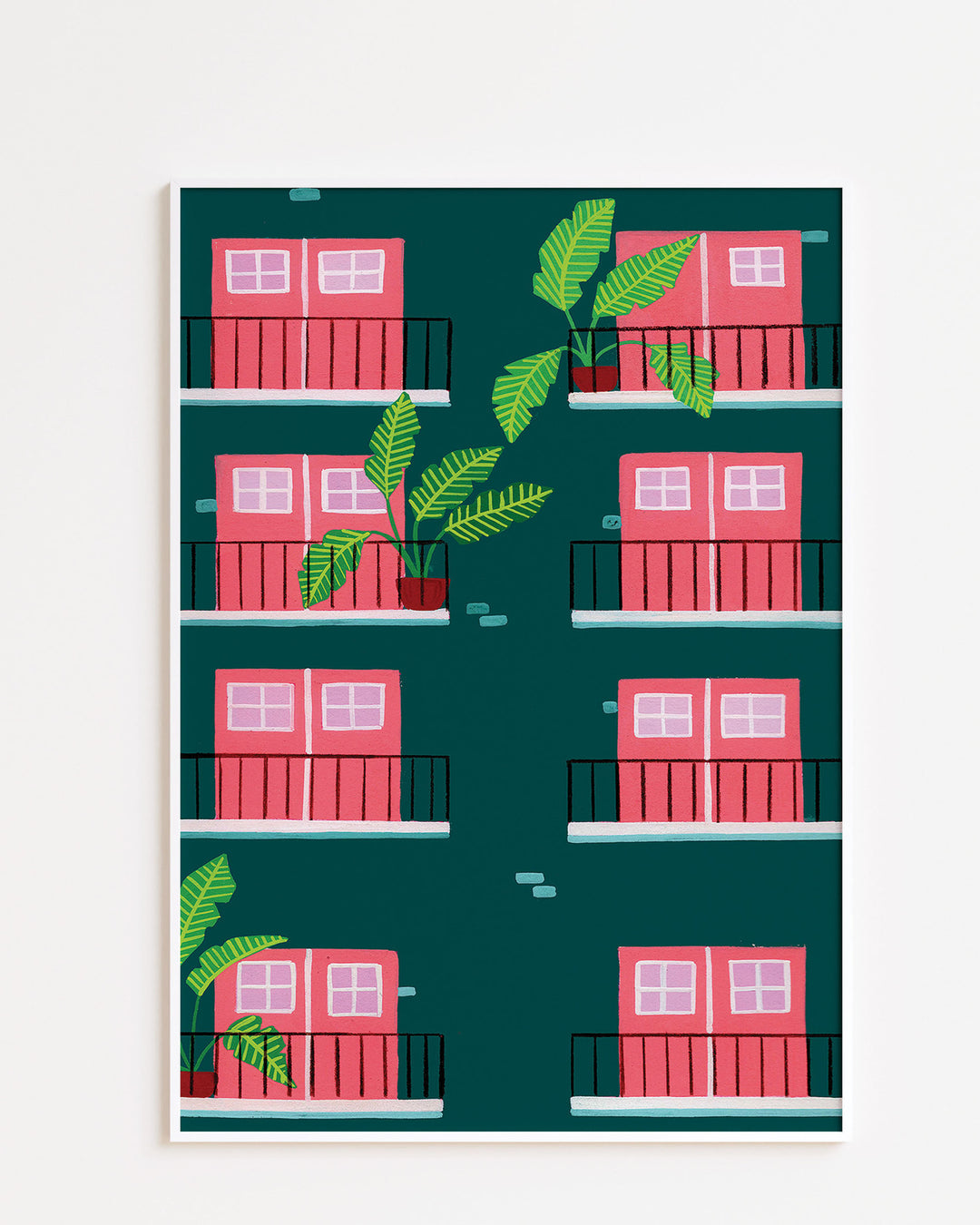 White Framed Art Print featuring a repeating pattern of pink double doors with windows on green building facades. Each door opens onto a small black railing balcony, and several balconies are adorned with potted tropical plants with large green leaves.