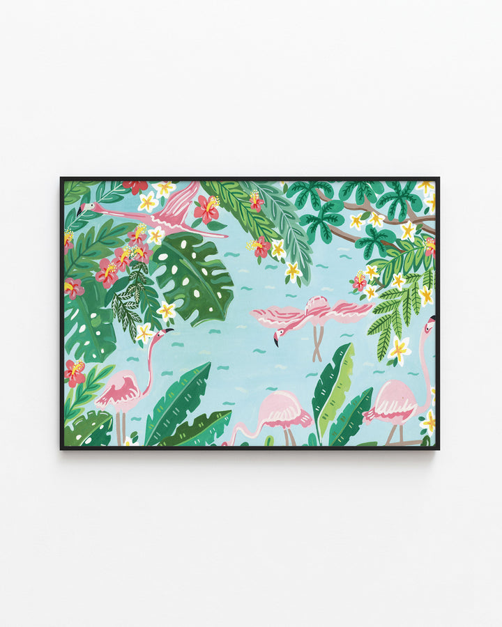 Black Framed Wall Art titled 'Flamingo Festivity' featuring pink flamingos wading in light blue water surrounded by lush green foliage, bright red and yellow flowers, and large tropical leaves.