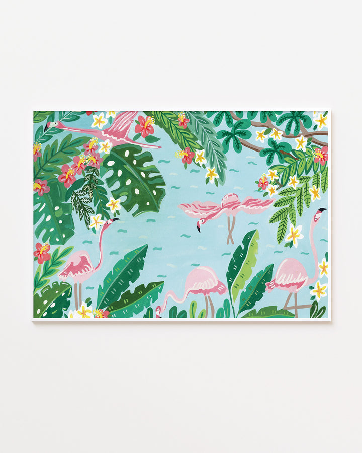 White Framed Wall Art titled 'Flamingo Festivity' featuring pink flamingos wading in light blue water surrounded by lush green foliage, bright red and yellow flowers, and large tropical leaves.