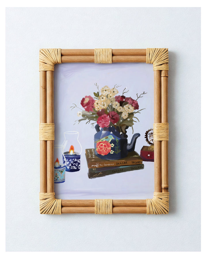 Framed artwork of a still life scene with flowers and books on a light blue background