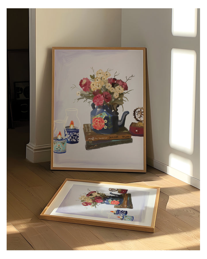 Framed artwork of a floral arrangement with teapots on a wooden floor.
