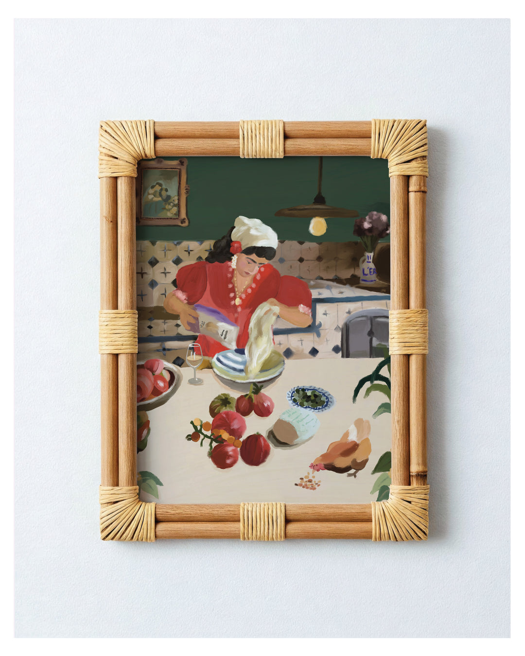A framed art print featuring a colorful vintage-style illustration of a woman in a kitchen, enclosed in a light natural bamboo frame with woven rattan accents, set against a plain light gray background.