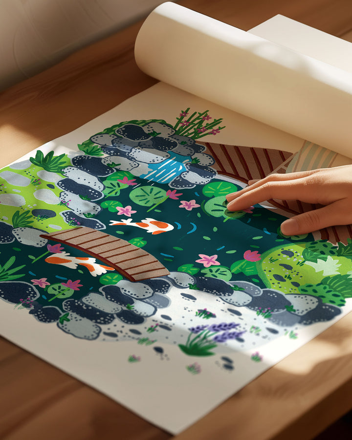 An Archival Art Print of a peaceful garden scene with a small koi pond, surrounded by rocks, blooming plants, and a wooden deck with a striped deck chair.