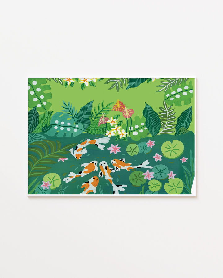White Framed Artwork of koi fish swimming in a lush green garden pond surrounded by vibrant tropical foliage and blooming flowers.