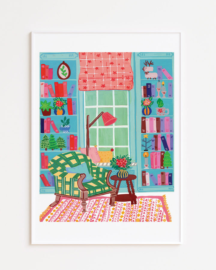 White Framed Artwork depicting a colourful reading nook with a comfy chair, bookshelves, and charming decor, titled 'Literary Retreat' by Little Berries Studio.