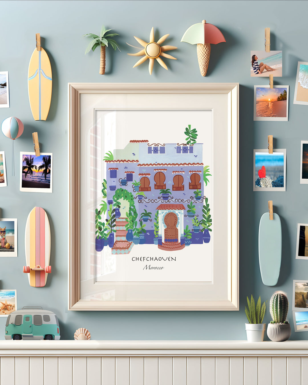 Framed Artwork  of a traditional Moroccan house in Chefchaouen by Little Berries Studio, featuring blue and white architecture, arched windows, and lush green plants.