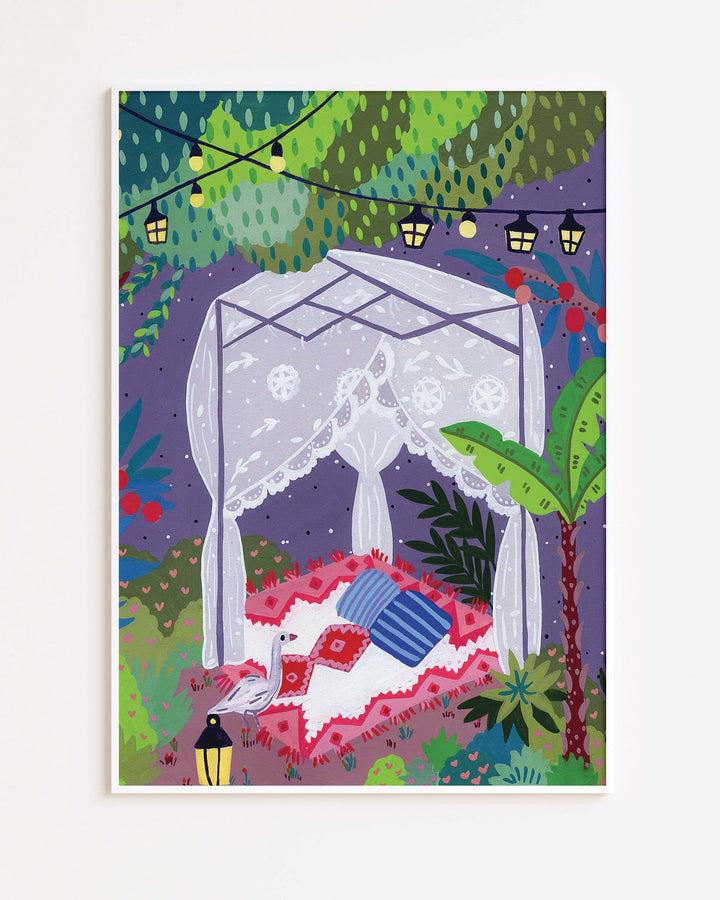 White Framed Art Print depicting a cozy outdoor scene under a canopy of trees. The centre features a draped canopy bed adorned with lace curtains, resting on a patterned red and white blanket with colourful cushions.