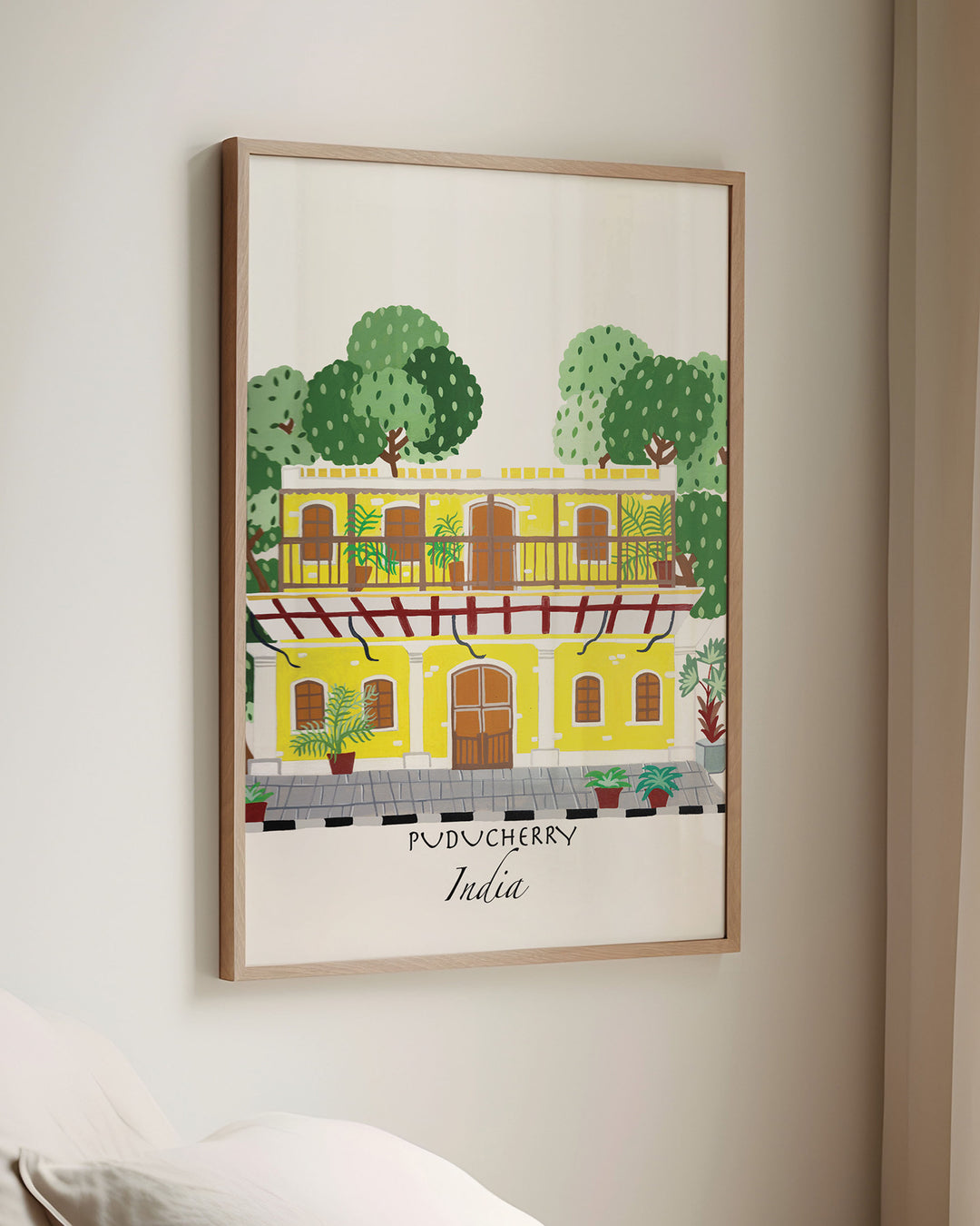 Framed Wall Art of a traditional yellow building in Puducherry, India, surrounded by lush greenery. Archival Print by Little Berries Studio.