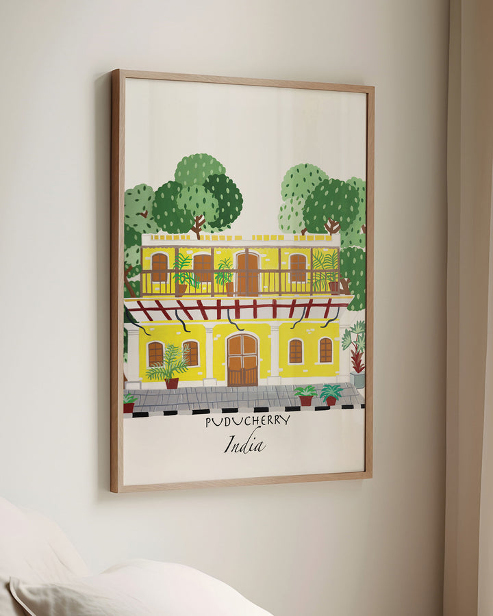 Framed Wall Art of a traditional yellow building in Puducherry, India, surrounded by lush greenery. Archival Print by Little Berries Studio.