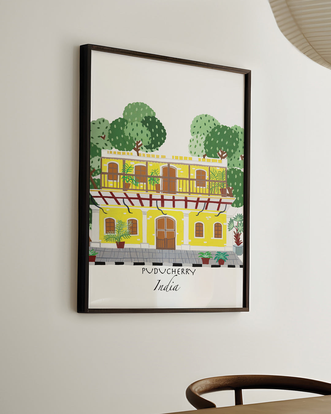 Ready-to-Hang Framed Wall Art of a traditional yellow building in Puducherry, India, surrounded by lush greenery. Archival Print by Little Berries Studio.