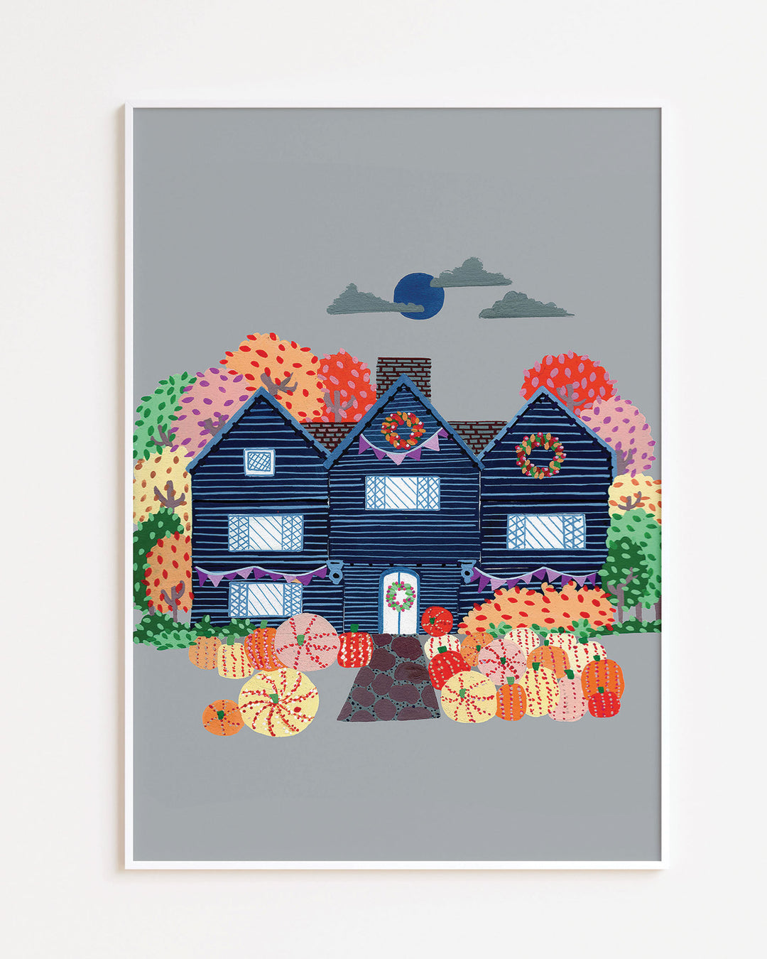 White Framed Artwork of a cosy, orange Victorian house surrounded by trees, capturing the essence of autumn with festive details and warm seasonal colours.