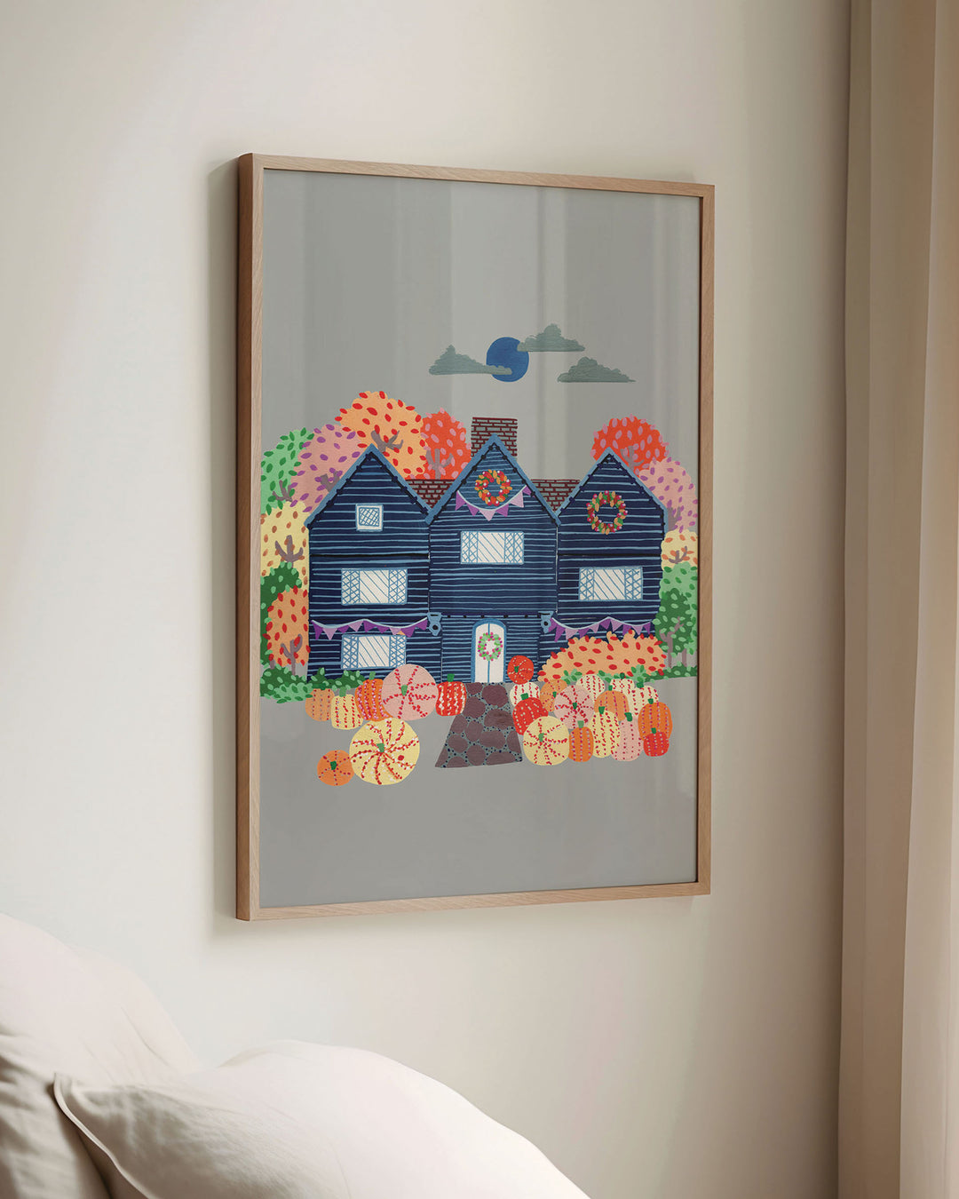 Framed Artwork of a cosy, orange Victorian house surrounded by trees, capturing the essence of autumn with festive details and warm seasonal colours.