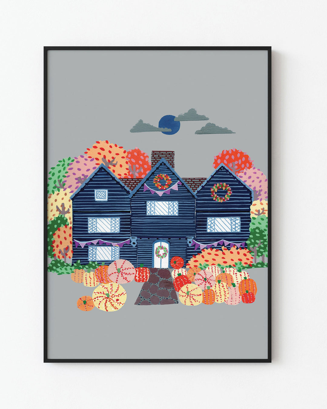 Black Framed Artwork of a cosy, orange Victorian house surrounded by trees, capturing the essence of autumn with festive details and warm seasonal colours.