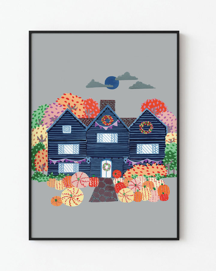 Black Framed Artwork of a cosy, orange Victorian house surrounded by trees, capturing the essence of autumn with festive details and warm seasonal colours.