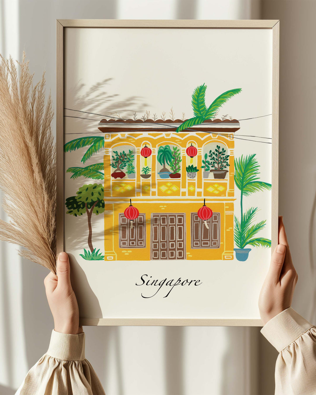Framed Artwork of a traditional Singaporean building with lush greenery and red lanterns, capturing the essence of Singapore. Archival Print by Little Berries Studio.