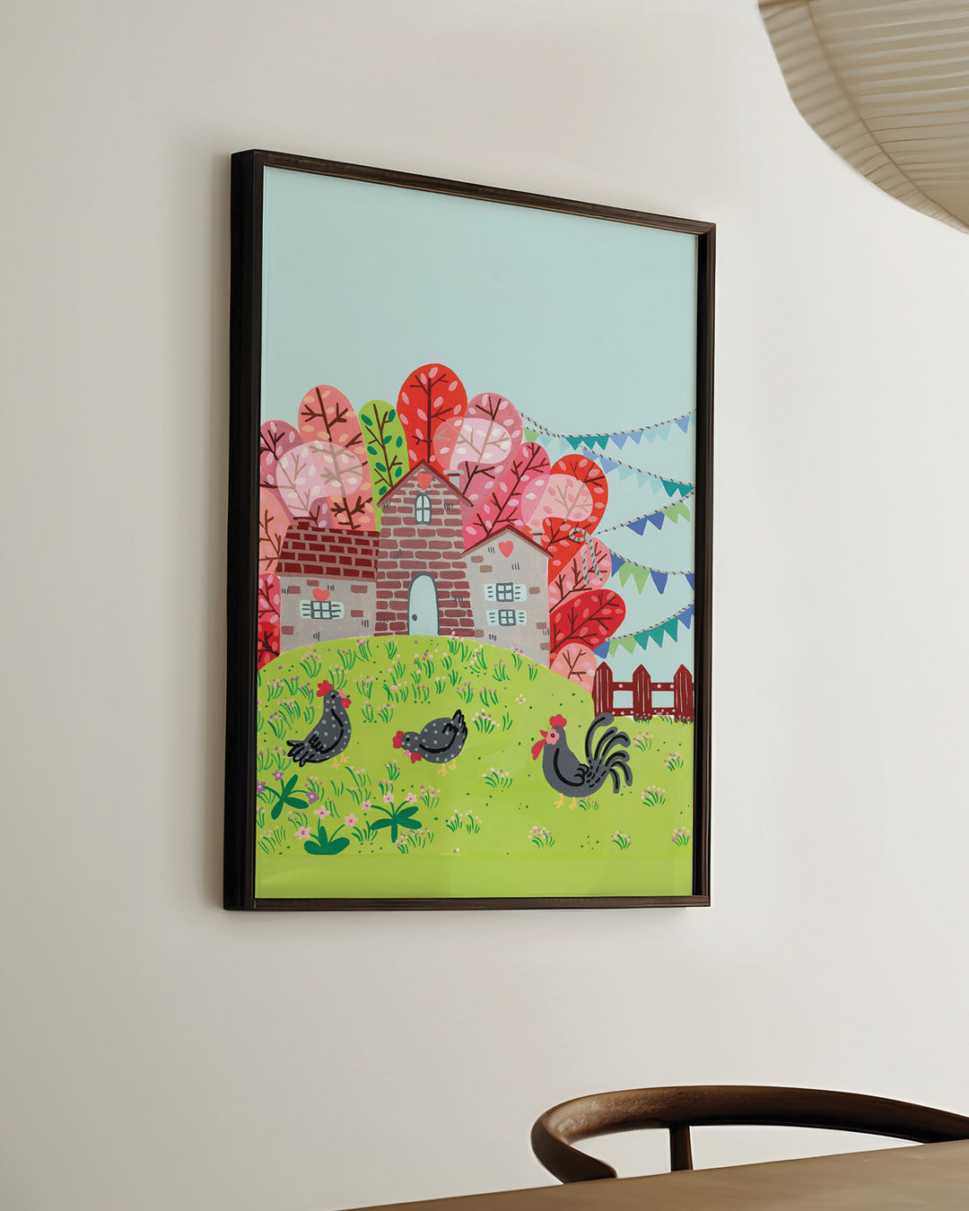 Ready-to-Hang Framed Wall Art of a countryside scene featuring a brick house surrounded by colourful trees with chickens grazing on a green hill, created by Little Berries Studio.