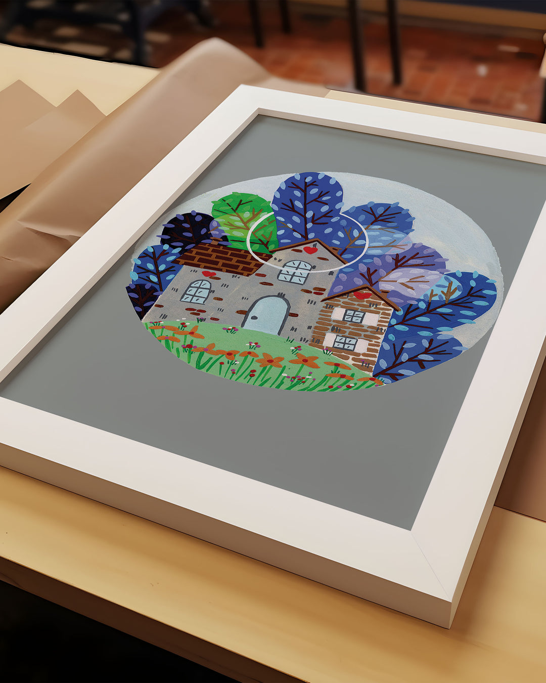 Whimsical Framed Art of a cozy countryside home surrounded by vibrant blue and green trees under a moonlit sky, created by Little Berries Studio.