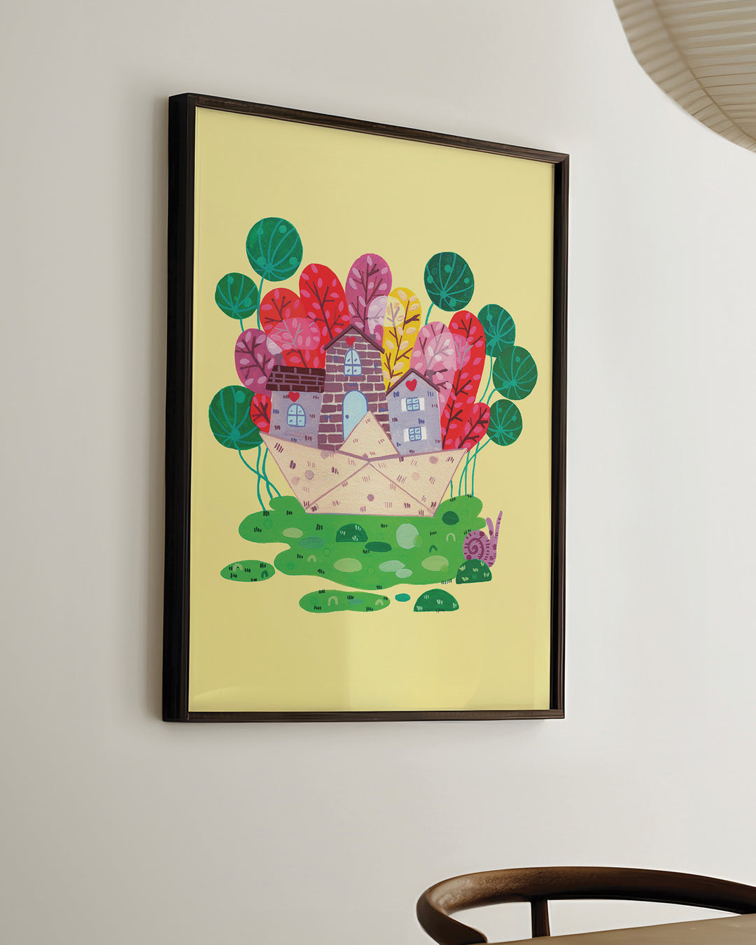 Ready-to-Hang Framed Wall Art of a cozy stone house nestled in a vibrant meadow, surrounded by colourful trees on a bright yellow background, ideal for decorating children's rooms.

