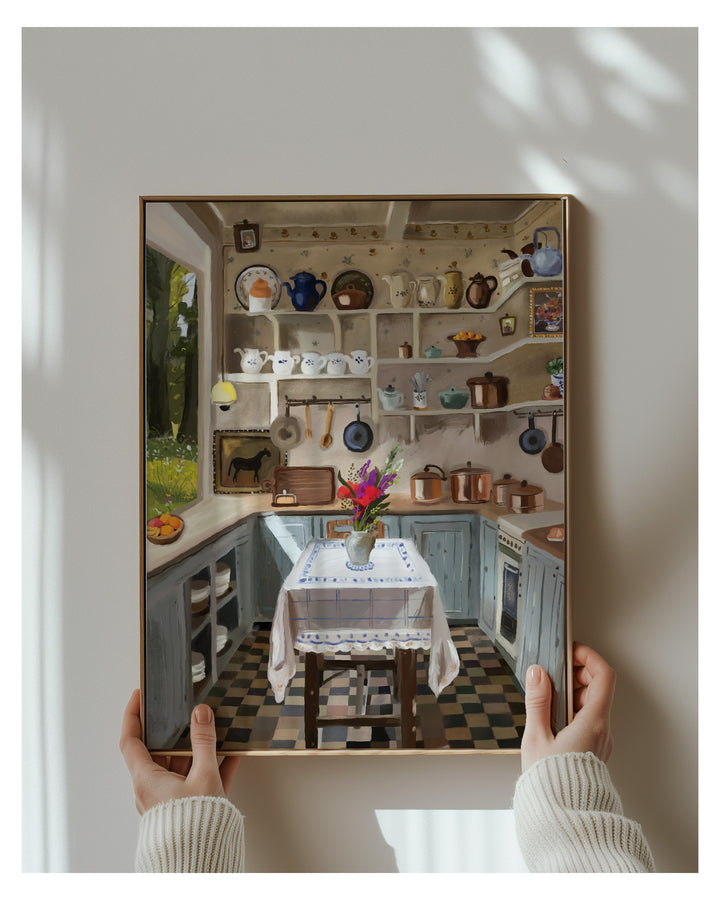Person holding a framed Artwork of a detailed kitchen scene.