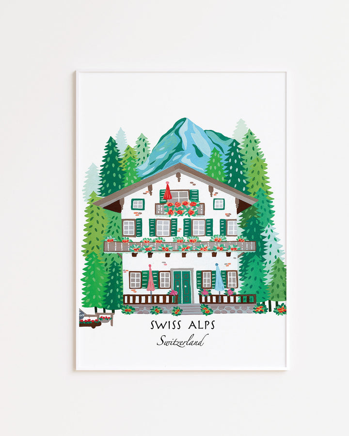 White Framed Artwork of a Swiss alpine chalet surrounded by lush pine trees and mountains, titled 'Swiss Alps, Switzerland,' by Little Berries Studio.