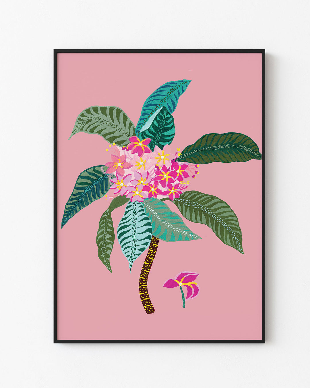 Black Framed Artwork titled 'Tropical Bloom', featuring vivid floral patterns set against a soft pink background.