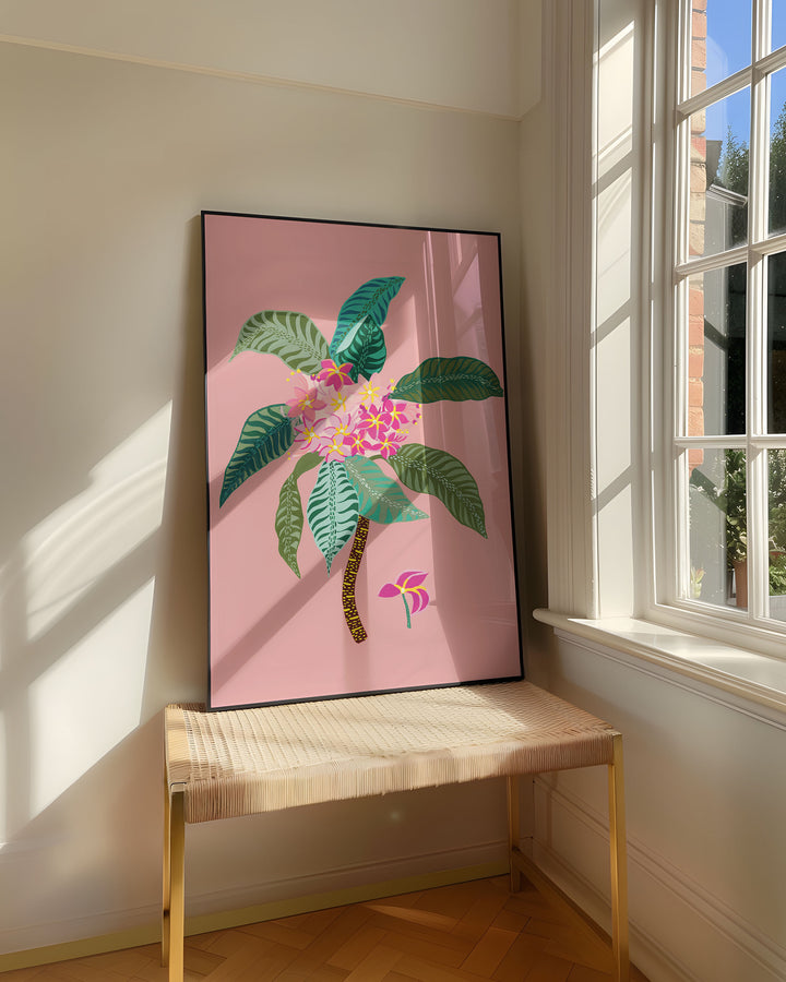 Framed Art Print,'Tropical Bouquet' by Little Berries Studio, resting on a woven bench near a sunlit window in a bright, airy room.