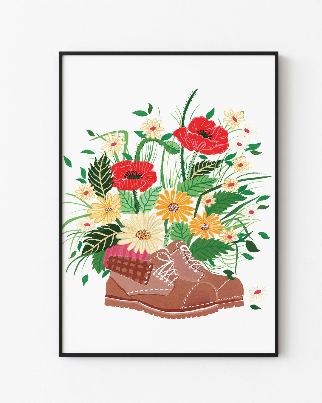 Black Framed Artwork, titled 'Wildflower Walk' features a brown hiking boot filled with an array of vibrant wildflowers, including red poppies, yellow daisies, and other colourful blossoms.
